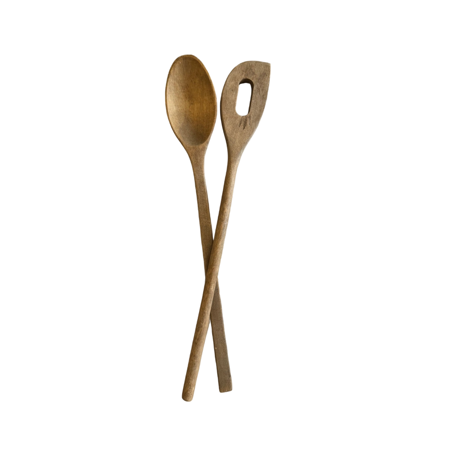 The "Pair of Vintage Wood Spoons" from Shoppe Maison are displayed on a black background with their handles crisscrossed at the bottom; one is a solid spoon while the other is a spatula featuring an elongated oval-shaped hole in the center.