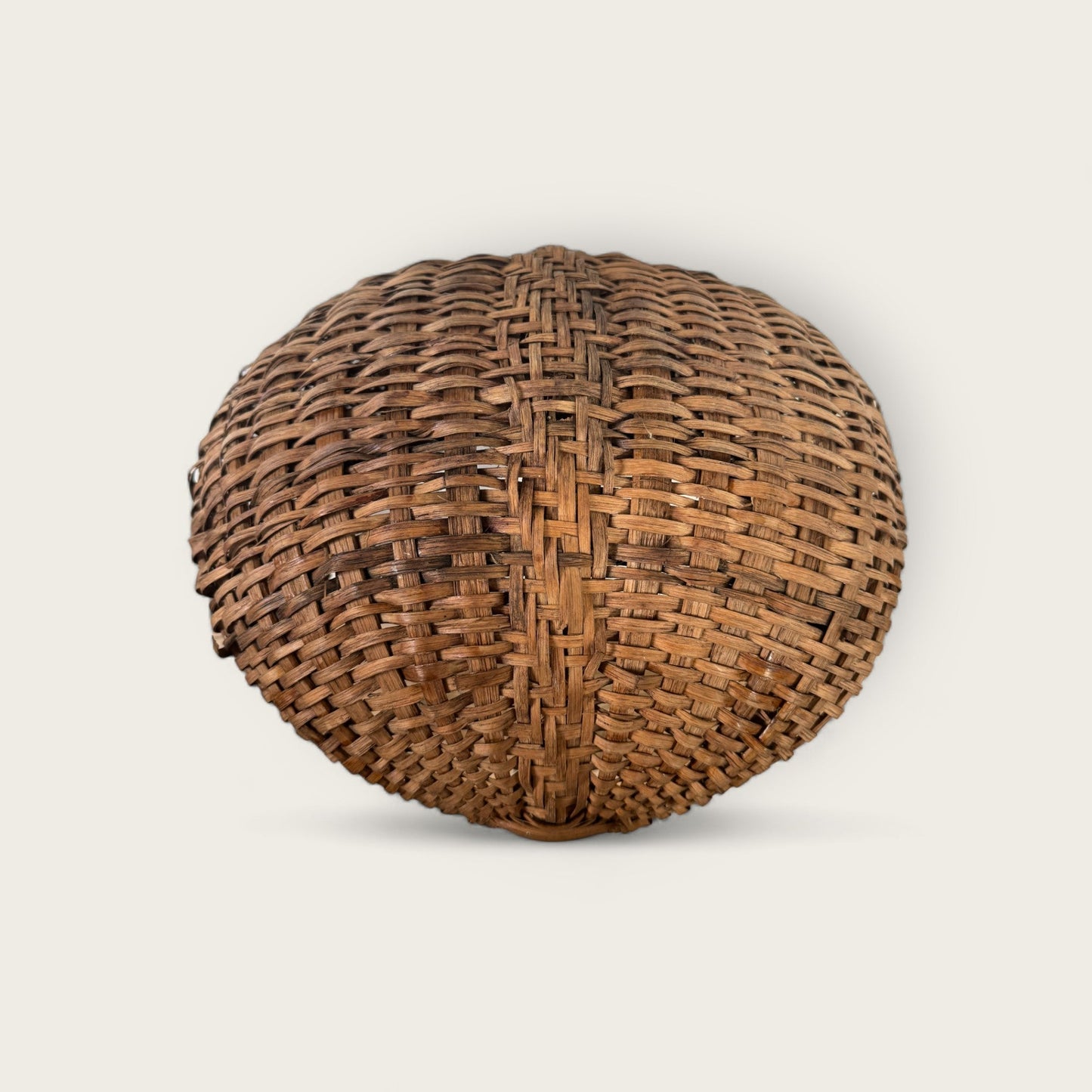 An intricately woven, spherical Antique Gather Basket II by Shoppe Maison is showcased against a plain background. The basket features parallel vertical and horizontal strips, creating a pleasing, symmetrical pattern and a textured, interlocking design perfect for decorative purposes.