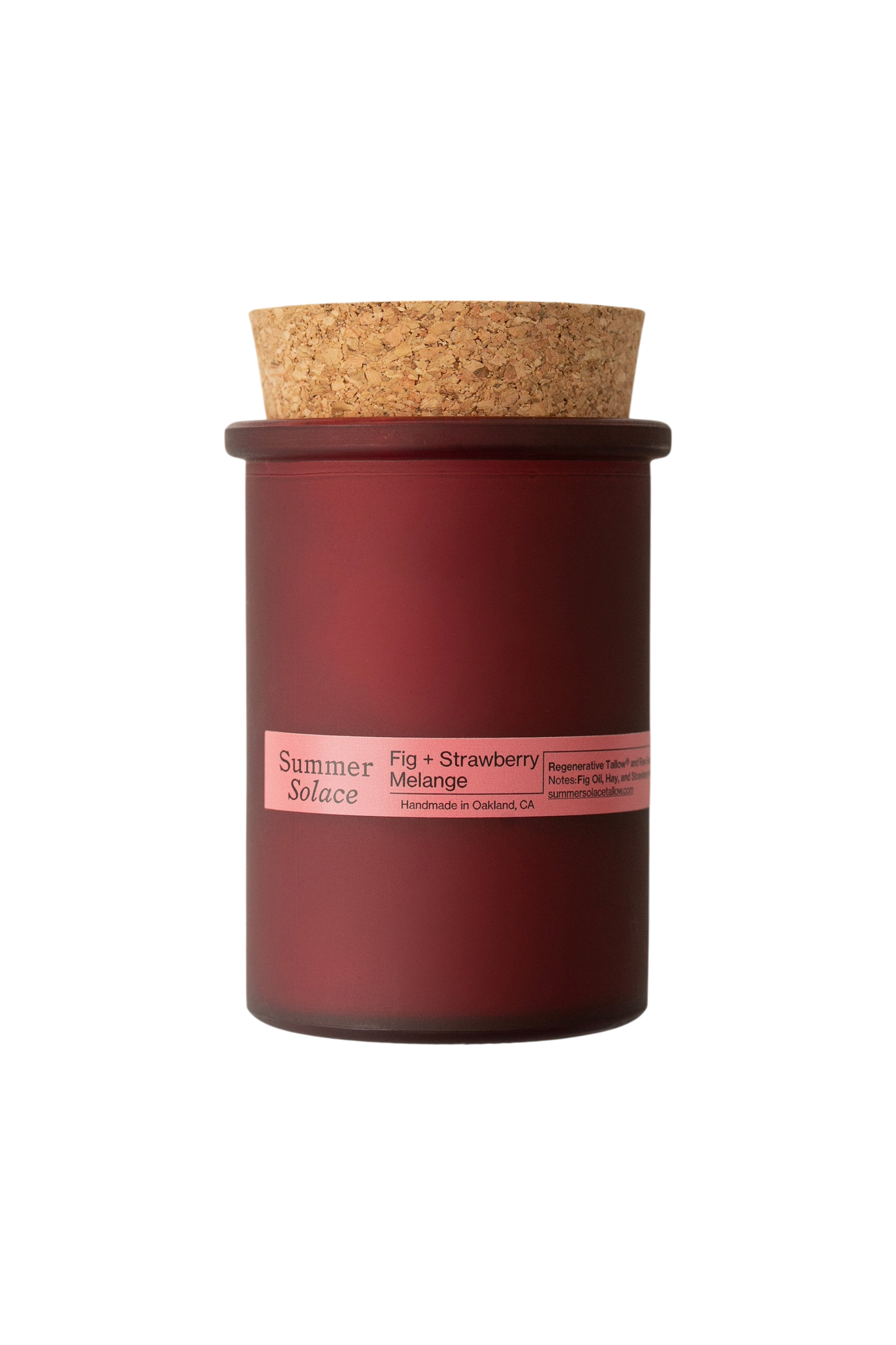 A burgundy glass candle jar with cork lid and pink label reading "Summer Solace, Fig + Strawberry Melange." The 6 oz. Regenerative Tallow® candle by Summer Solace Tallow stands out against a black background. Crafted in Oakland, CA.