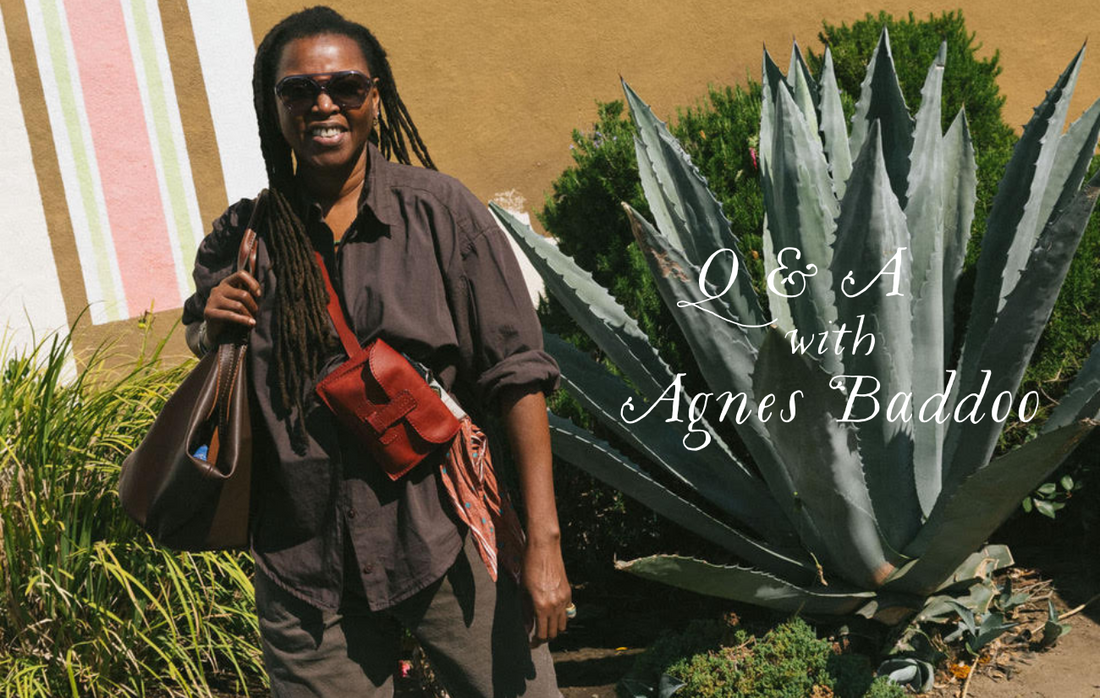 Agnes baddoo standing infront of an agave plant with a few of her leather bags