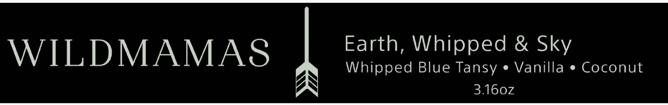 Black rectangular label featuring “WILDMAMAS” on the left, a vertical arrow in the center, and “Earth, Whipped & Sky 3.16oz,” plus scent notes and "Regenerative Bison Tallow Skincare," in pale gray font on the right.
