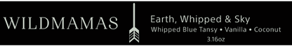 Black rectangular label featuring “WILDMAMAS” on the left, a vertical arrow in the center, and “Earth, Whipped & Sky 3.16oz,” plus scent notes and "Regenerative Bison Tallow Skincare," in pale gray font on the right.