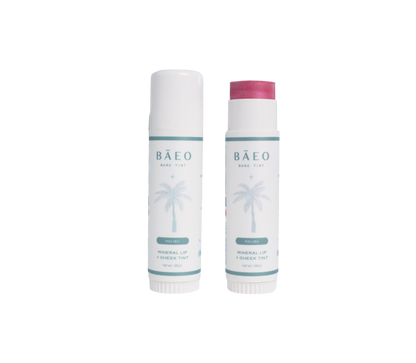 Two tubes of Bare Essential Organics' bare tint 'malibu' are shown. One is closed with a white cap, while the other is open, revealing its natural pink color. Both have a palm tree design on their labels.
