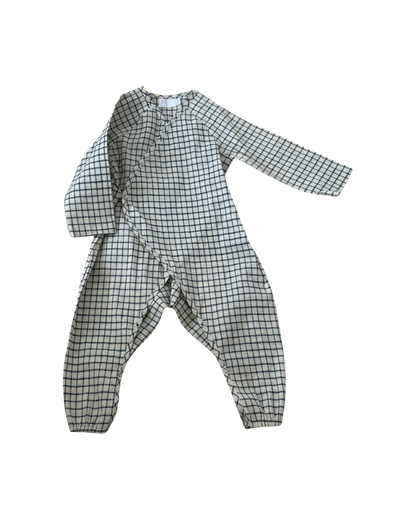 The APRÈS WRAP blue check by cabane childrenswear is a long-sleeve kids' jumpsuit made from breathable fabric with elastic cuffs and a blue check pattern, shown laid flat on a white background.