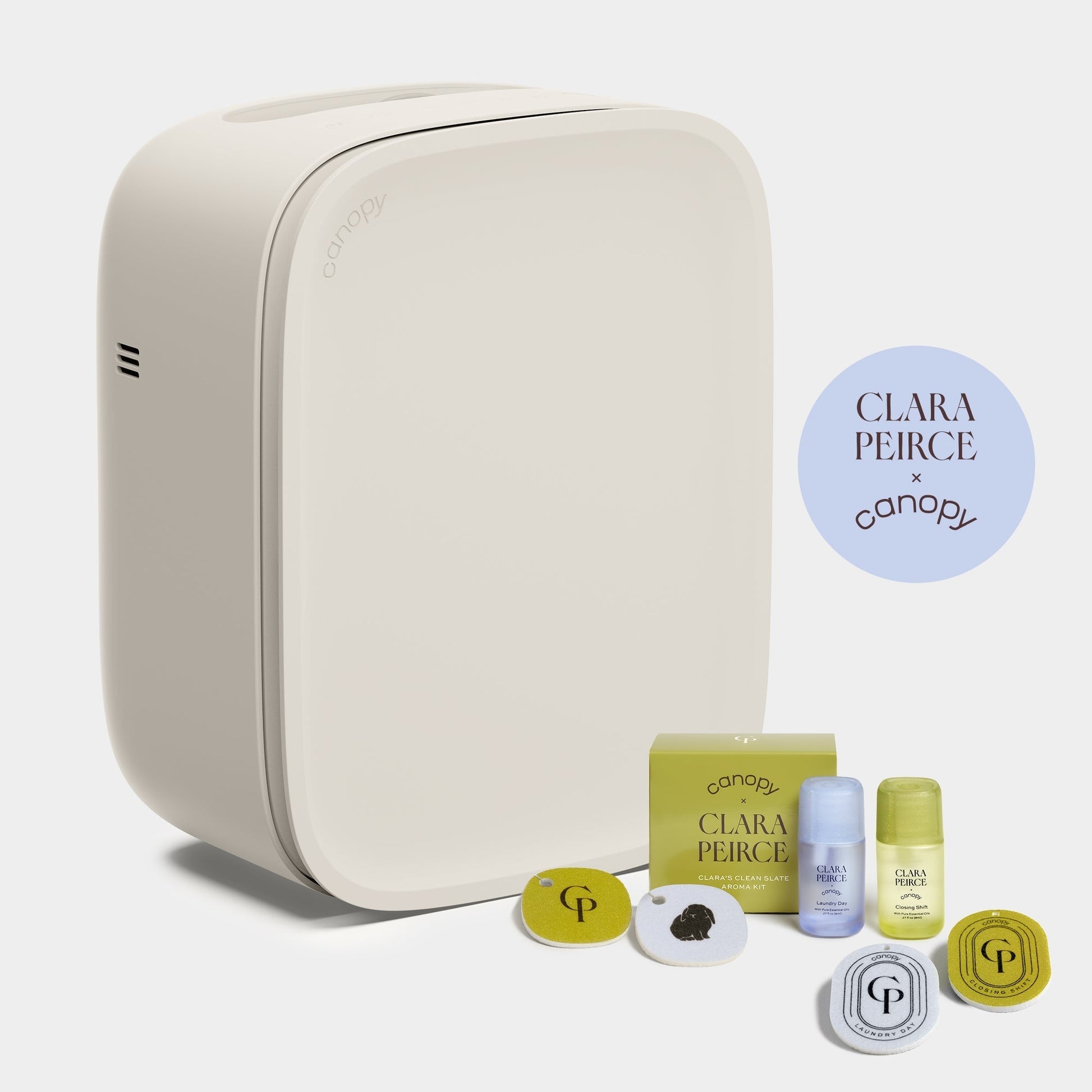 Clara Peirce Polly A sleek, Canopy Bedside Air Purifier is shown with skincare items and fragrance discs next to a round "CLARA PEIRCE x canopy" logo, fulfilled by Canopy.