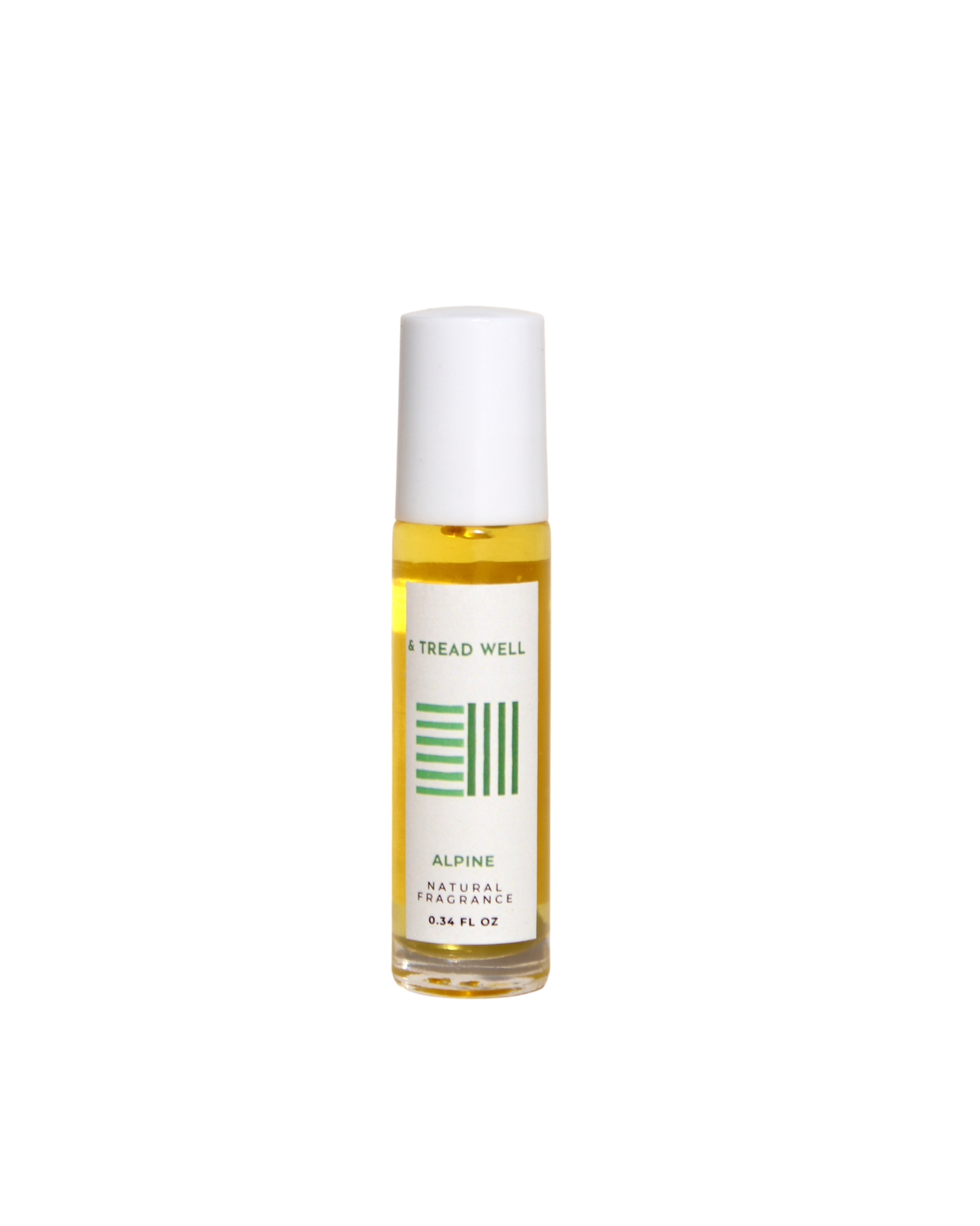 A small glass bottle with a white cap and roll-on applicator contains yellow "Natural Fragrance - Alpine" by & Tread Well (0.34 FL OZ), featuring organic essential oils and a label with green design elements.