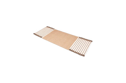 Introducing the Harda Ayurvedic Yoga Mat by Bennd Yoga, a rectangular mat crafted from organic cotton featuring a natural beige center and edged with alternating brown and white striped patterns.