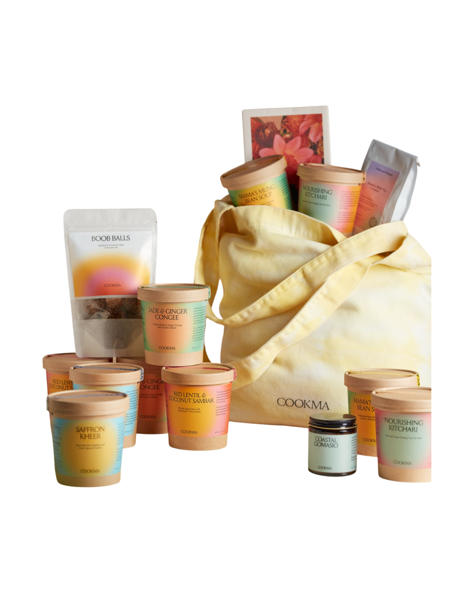 The Cookma Mama Bundle features nourishing meals like Ayurvedic kitchari, colorful jars, tubs, pouches, recipe cards, and a small jar—all arranged around a yellow tote for holistic wellness.