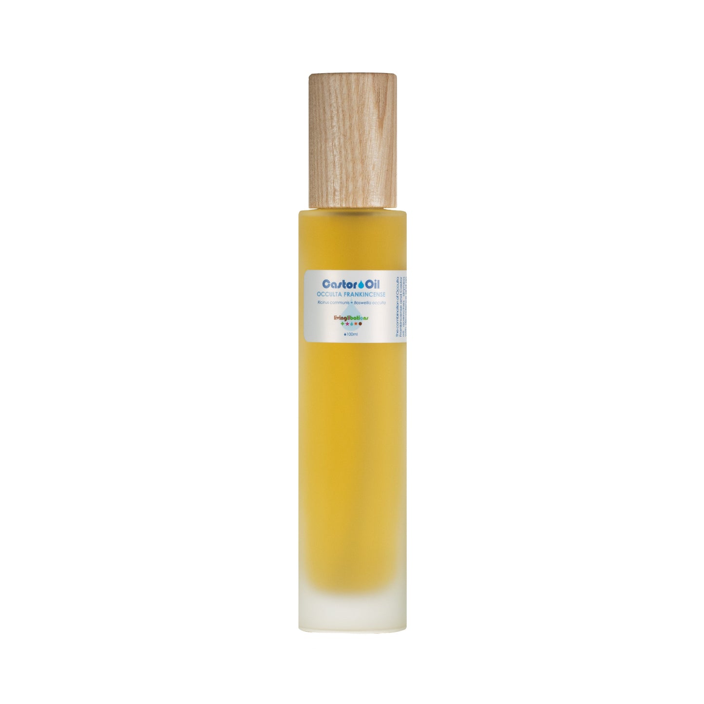 Living Libations' Castor Oil + Occulta Frankincense comes in a tall, slender bottle with a wooden cap. It contains rich ricinoleic acids for optimal skin conditioning. The yellow oil fills the bottle, which features a white label with delicate floral graphics and slightly blurred text.