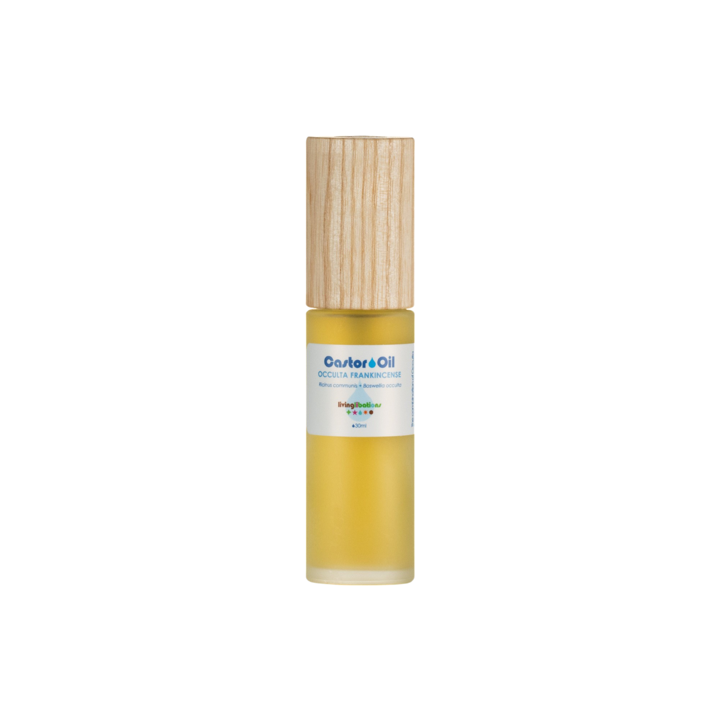 A small cylindrical gold bottle with a light wooden cap, containing cold-pressed Castor Oil rich in ricinoleic acids, is labeled "Castor Oil + Occulta Frankincense." It features a small white label with colorful text, set against a plain black background. The brand is Living Libations.