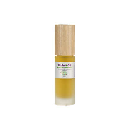 The Living Libations Castor Oil + Rosemary Verbenone comes in a small glass bottle with a wooden cap, revealing amber liquid high in ricinoleic acid through its frosted bottom.