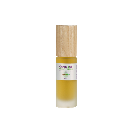 The Living Libations Castor Oil + Rosemary Verbenone comes in a small glass bottle with a wooden cap, revealing amber liquid high in ricinoleic acid through its frosted bottom.