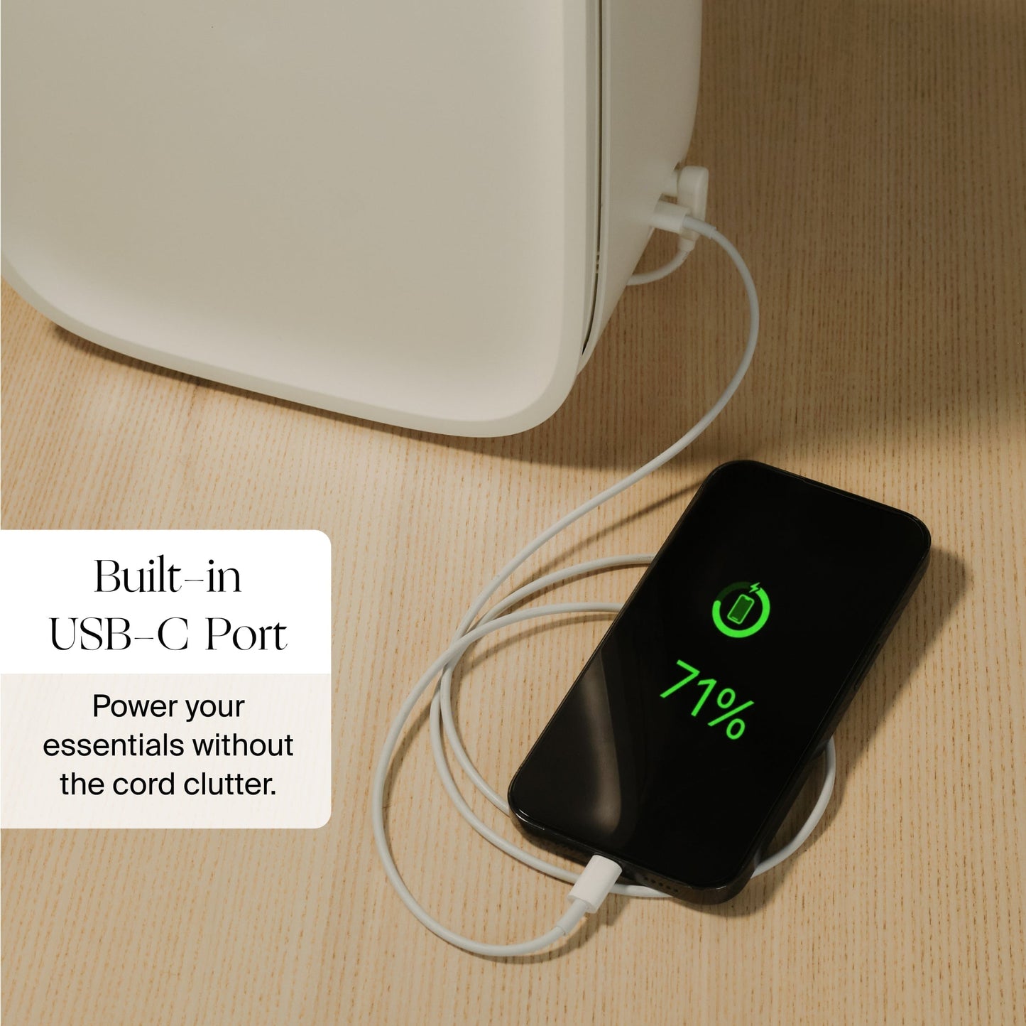 A smartphone charges via USB-C on the Canopy Nursery Air Purifier. The phone screen shows 71% battery. On-screen text: "Built-in USB-C Port. Power your essentials without cord clutter, Fulfilled by Canopy.