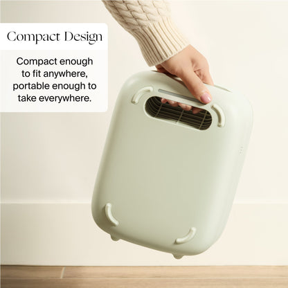 A hand holds the Canopy Nursery Air Purifier—a compact, light green device with a handle—against a light background. Text: “Compact and portable. Fits anywhere, goes everywhere. Fulfilled by Canopy.”.