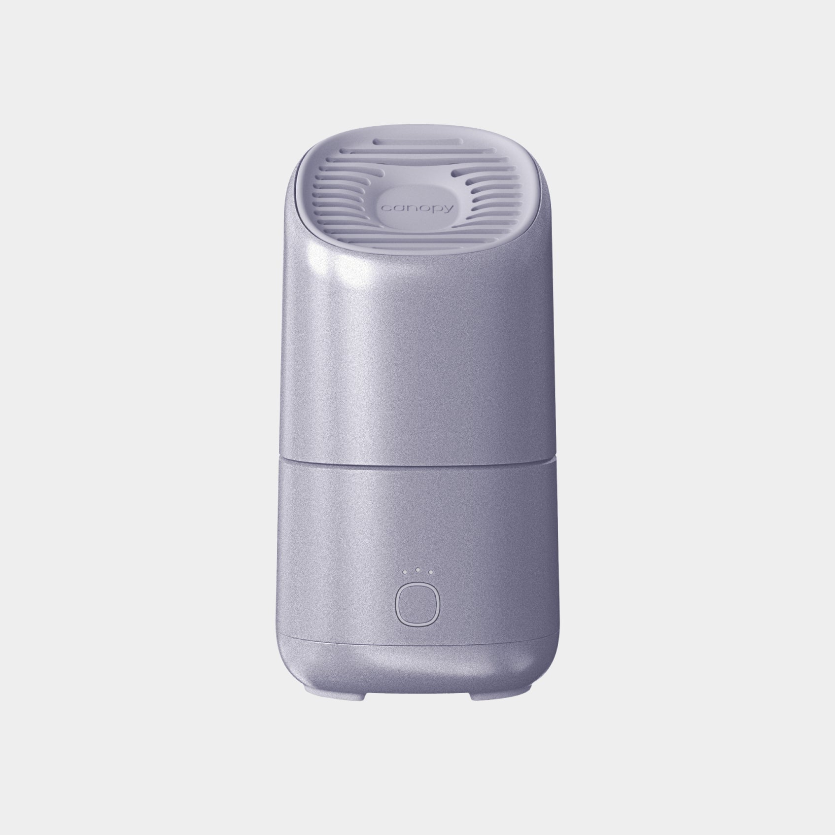 A sleek light purple Canopy Portable Humidifier, featuring a rounded rectangular shape, vented top, and single-button control with three indicator lights on the front, set against a plain light background. Fulfilled by Canopy.