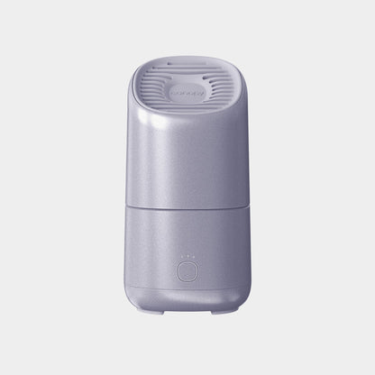 A sleek light purple Canopy Portable Humidifier, featuring a rounded rectangular shape, vented top, and single-button control with three indicator lights on the front, set against a plain light background. Fulfilled by Canopy.