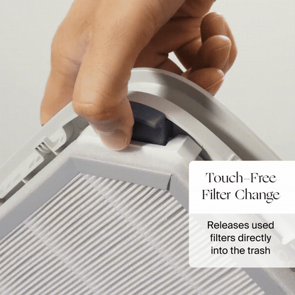 A hand presses a button on a Canopy Nursery Air Purifier, dropping a used filter into the trash. Text: "Touch-free filter change. Disposes filters directly into the trash." Fulfilled by Canopy.