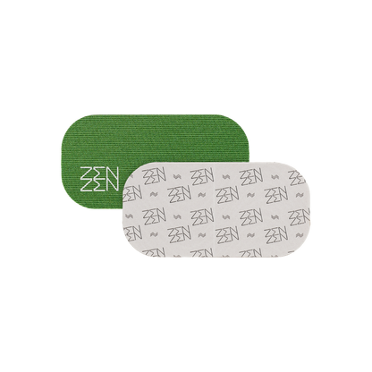 Two rounded rectangular patches overlap: a green patch with white "ZEN" (Zenzentape) logo and another with a repeating grey "ZEN" pattern on white. Both represent the Evergreen Mouthtape, designed for comfortable nasal breathing. Background is plain white.
