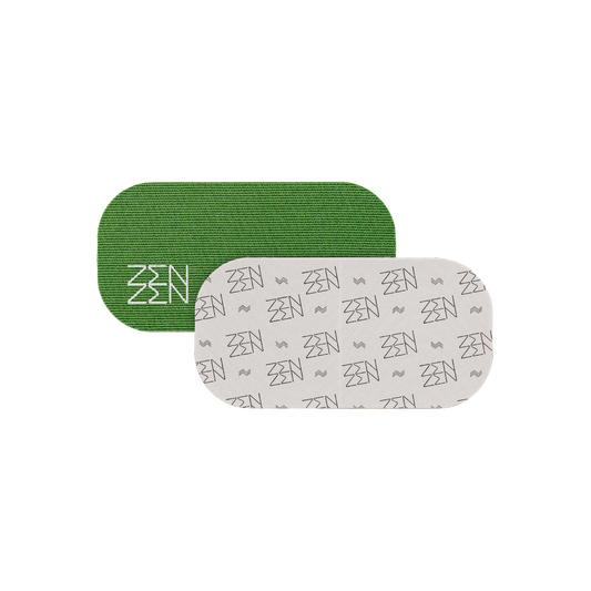 Two rounded rectangular patches overlap: a green patch with white "ZEN" (Zenzentape) logo and another with a repeating grey "ZEN" pattern on white. Both represent the Evergreen Mouthtape, designed for comfortable nasal breathing. Background is plain white.