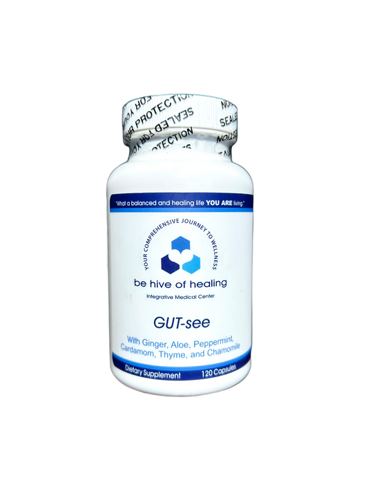 A white bottle labeled "Be Hive of Healing Wellness Store" with the product name "GUT-see - Digestion Supplement" contains an herbal blend of ginger, aloe, peppermint, cardamom, thyme, and chamomile. The bottle holds 120 capsules and is set against a black background.