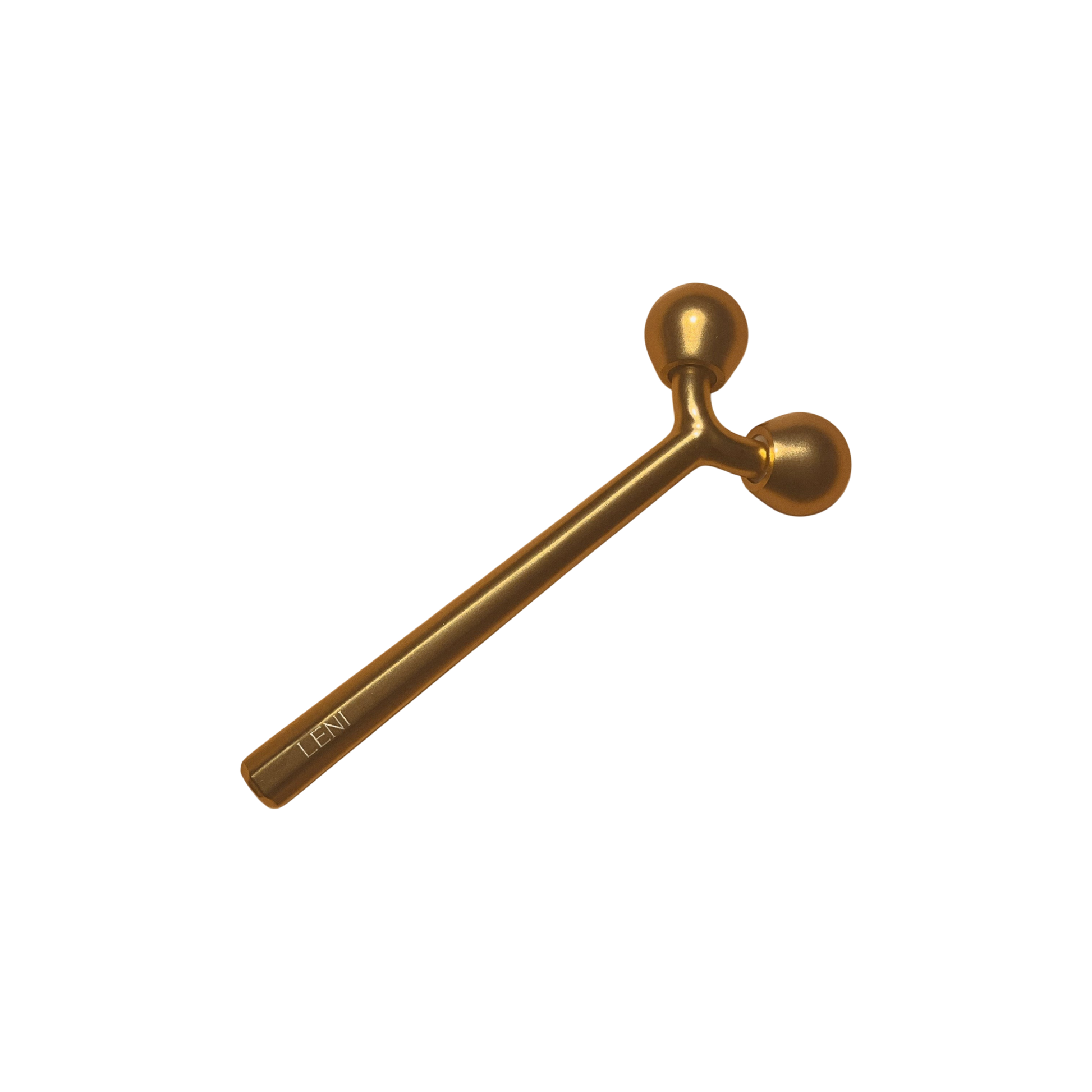 The LENI THE FACE TOOL, a gold-toned metal facial roller with a handle and twin round ends, is perfect for lymphatic massage and better skincare absorption. It is shown against a plain white background.
