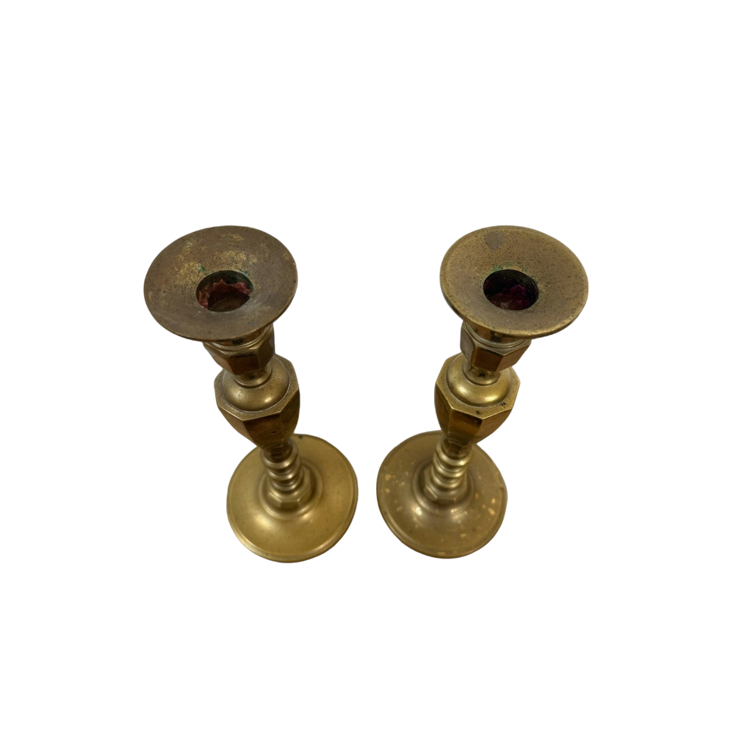 A stunning pair of Vintage Brass Candle Holders from Shoppe Maison, featuring a simple, cylindrical design and a polished finish. The flat top part, slightly wider than the stem and designed for candle insertion, highlights their elegant craftsmanship. Displayed against a black background, they exemplify the exquisite homewares collection offered by Shoppe Maison.