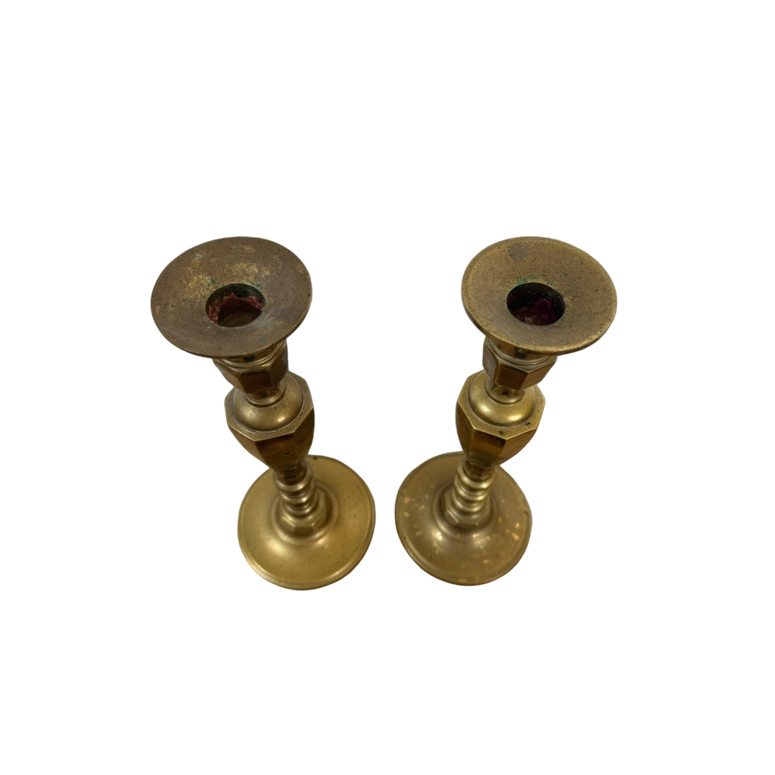 A stunning pair of Vintage Brass Candle Holders from Shoppe Maison, featuring a simple, cylindrical design and a polished finish. The flat top part, slightly wider than the stem and designed for candle insertion, highlights their elegant craftsmanship. Displayed against a black background, they exemplify the exquisite homewares collection offered by Shoppe Maison.