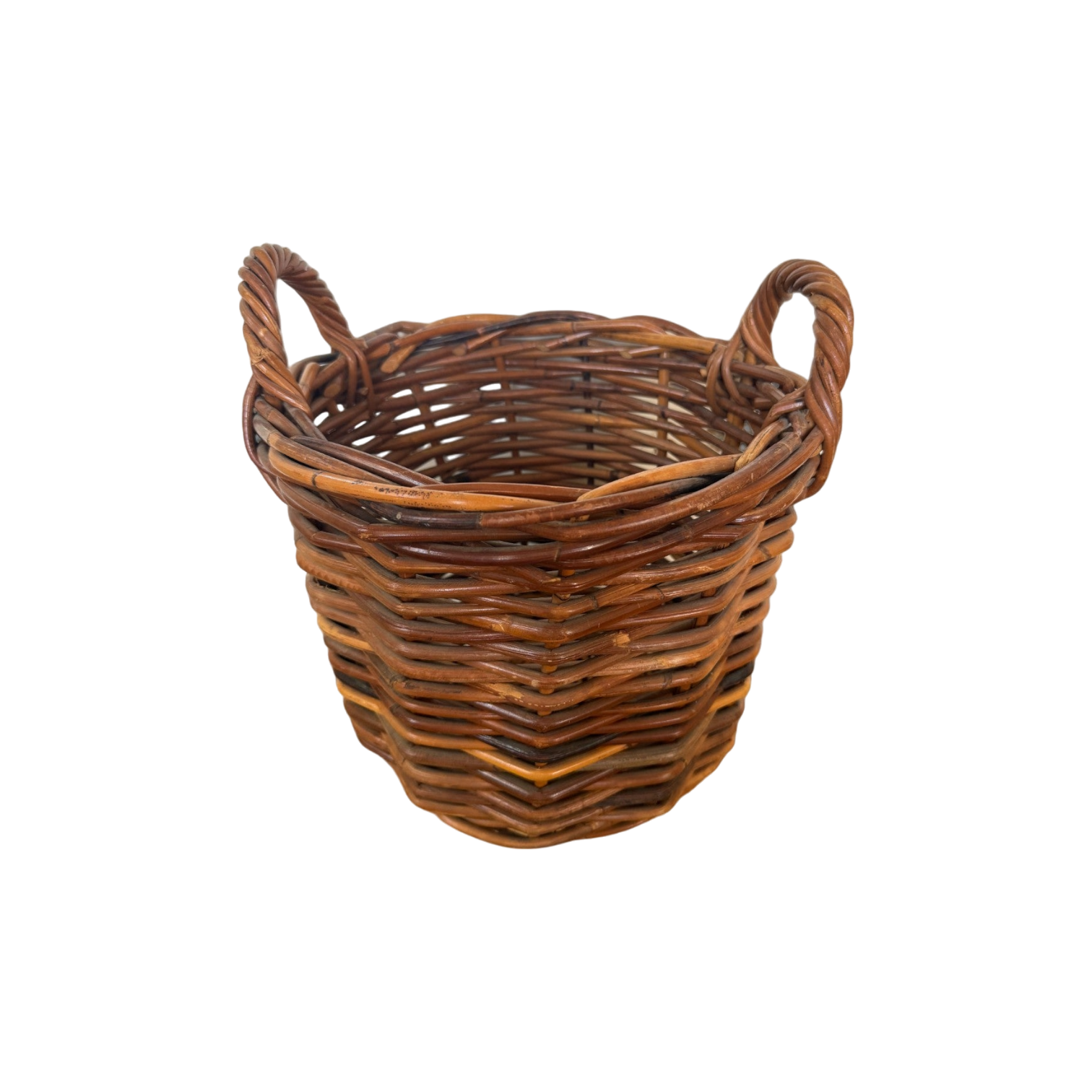 The Vintage Woven Basket with Handles from Shoppe Maison is a round, slightly tapered basket made of natural brown rattan. It features two looped handles on either side and boasts a tight, uniform weave.