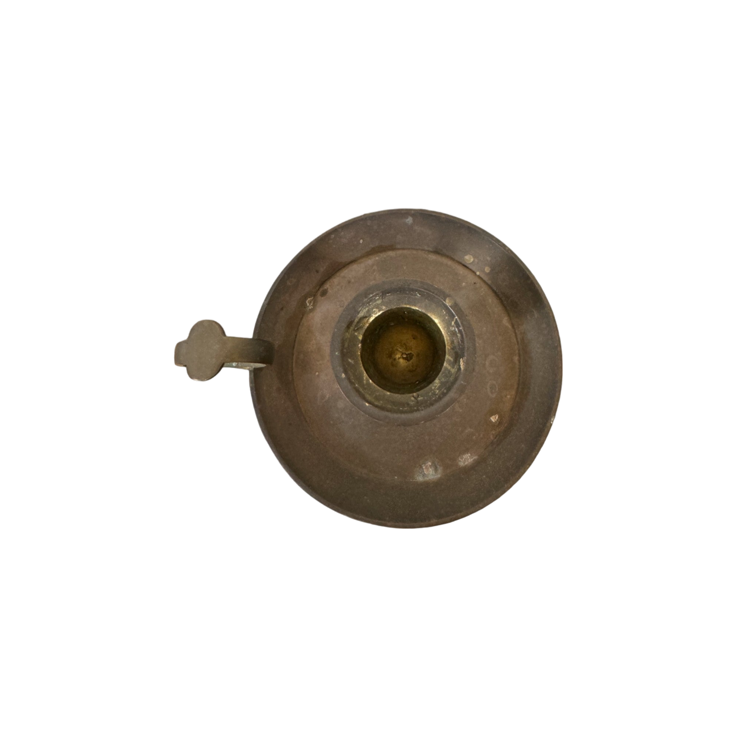 Top view of Shoppe Maison's Brass Candle Holder II, featuring a circular base and a finger ring handle, set against a black background. The holder exhibits a weathered appearance with a central cavity for the candle and an integrated drip tray to catch melted wax.