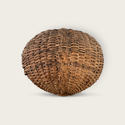 An intricately woven, spherical Antique Gather Basket II by Shoppe Maison is showcased against a plain background. The basket features parallel vertical and horizontal strips, creating a pleasing, symmetrical pattern and a textured, interlocking design perfect for decorative purposes.