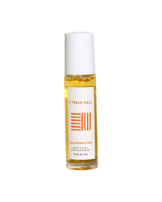 A 0.34 fl oz glass bottle of & Tread Well's Natural Fragrance – Illumination, with a white cap and orange design, offers portable aromatherapy for stress relief.