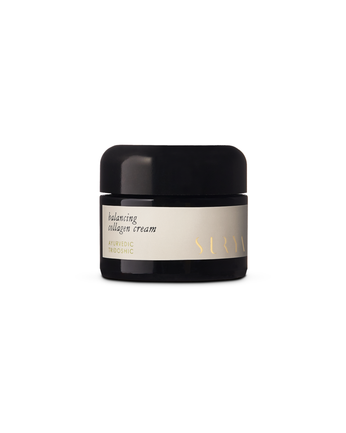A jar of Surya Balancing Collagen Cream, enriched with Ayurvedic Tridoshic properties and botanical retinol, is displayed against a black background. The natural face cream's black jar features a light-colored label adorned with gold text.
