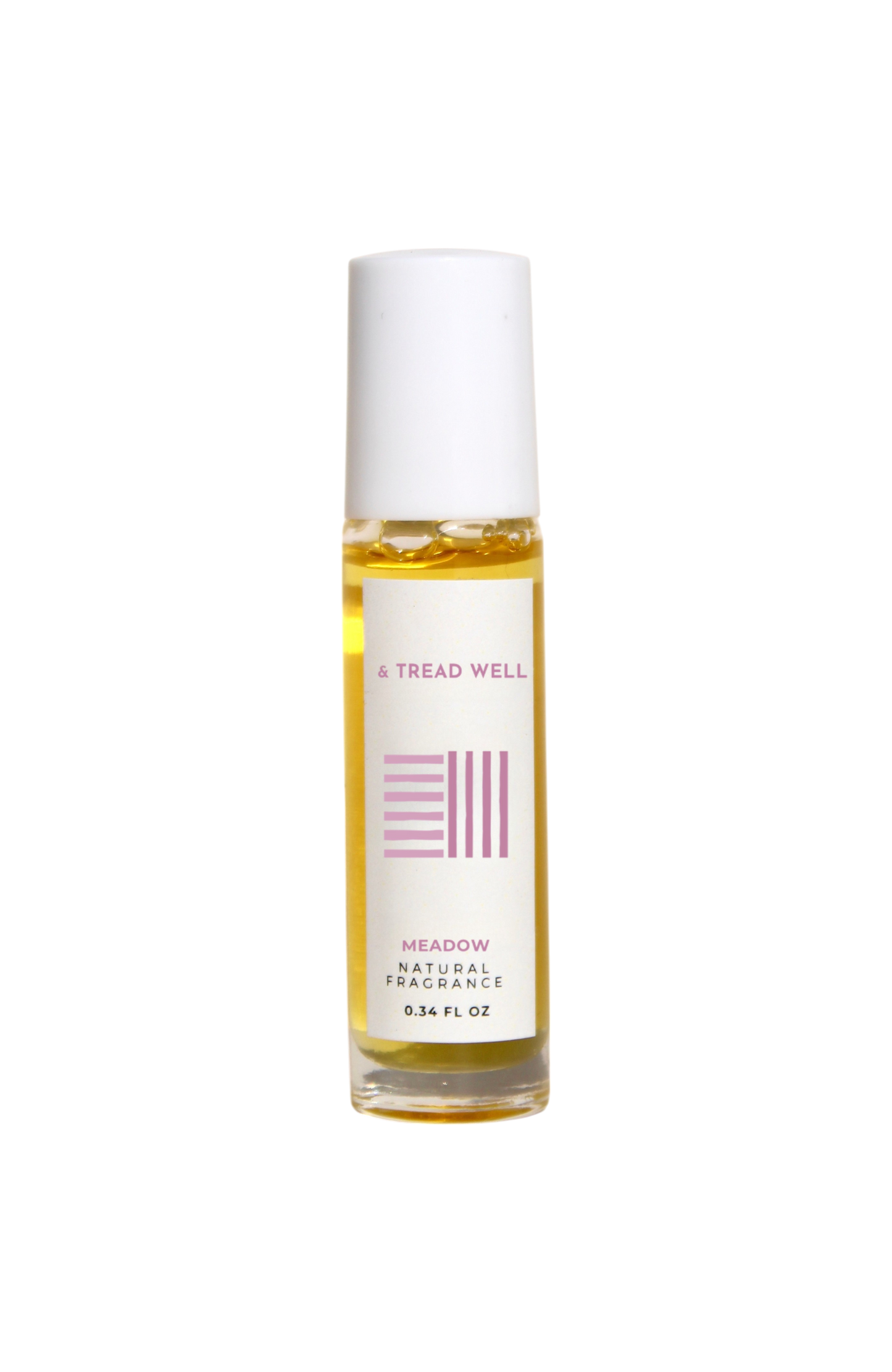 A small glass bottle of & Tread Well Natural Fragrance – Meadow, an organic floral perfume with a white cap and pink-and-black label, containing yellow liquid. This Hudson Valley roll-on is handcrafted, elegant, and natural.