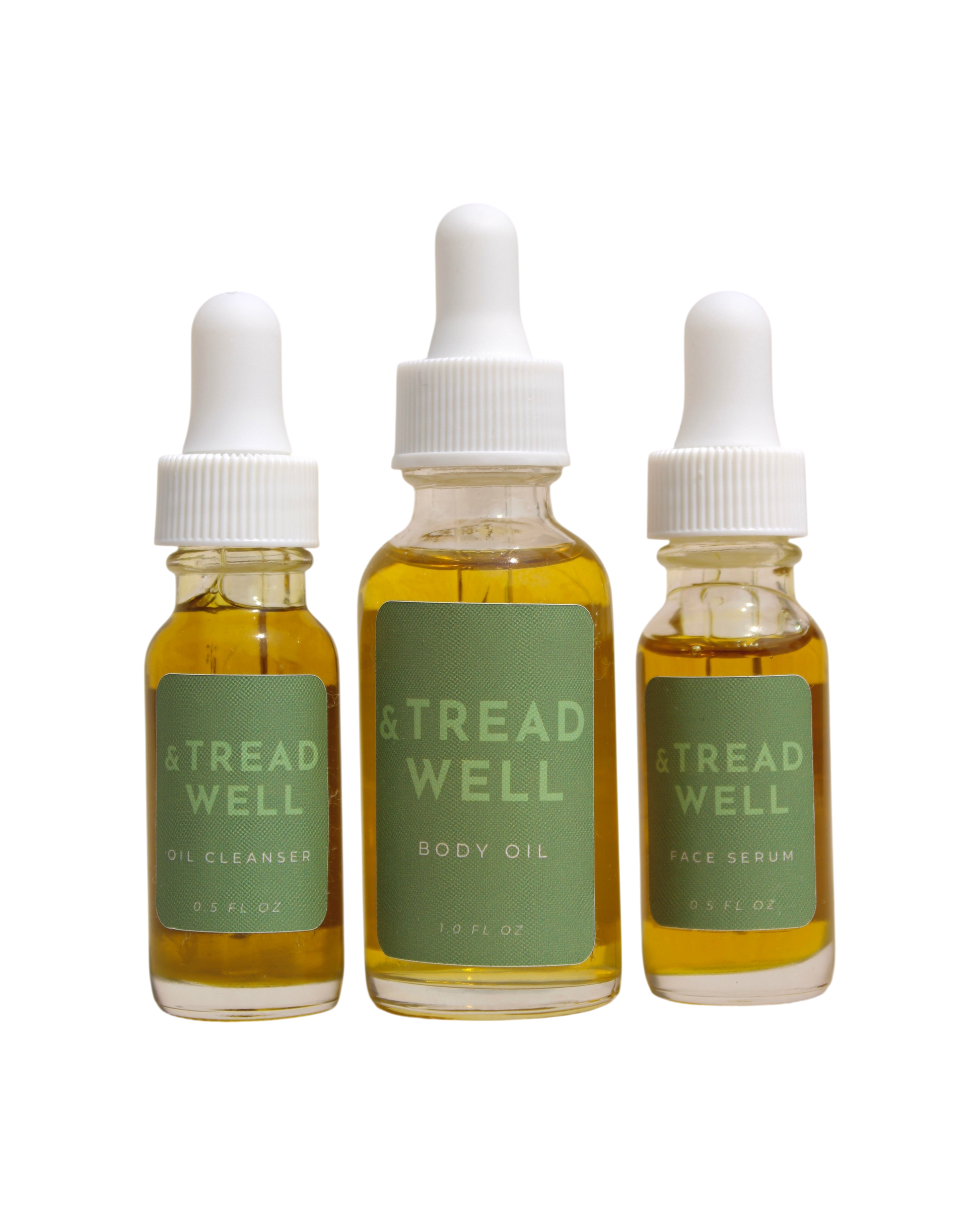 The & Tread Well Mini Essentials set features three travel-size skincare products—Oil Cleanser, Body Oil, and Face Serum—in clear bottles with green labels and white dropper caps, each containing yellow liquid.