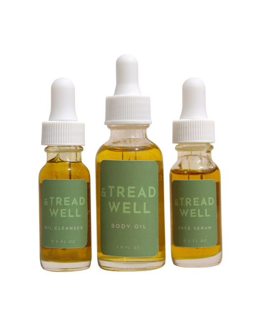 The & Tread Well Mini Essentials set features three travel-size skincare products—Oil Cleanser, Body Oil, and Face Serum—in clear bottles with green labels and white dropper caps, each containing yellow liquid.