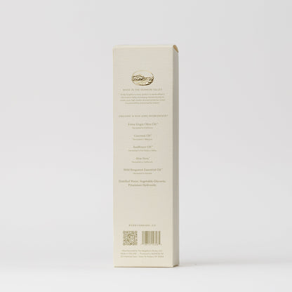 The back of My Neighbor’s Tallow Blue Tansy Hand Wash box features a gold logo, ingredients, company info, and QR codes in elegant fine print on a white background.