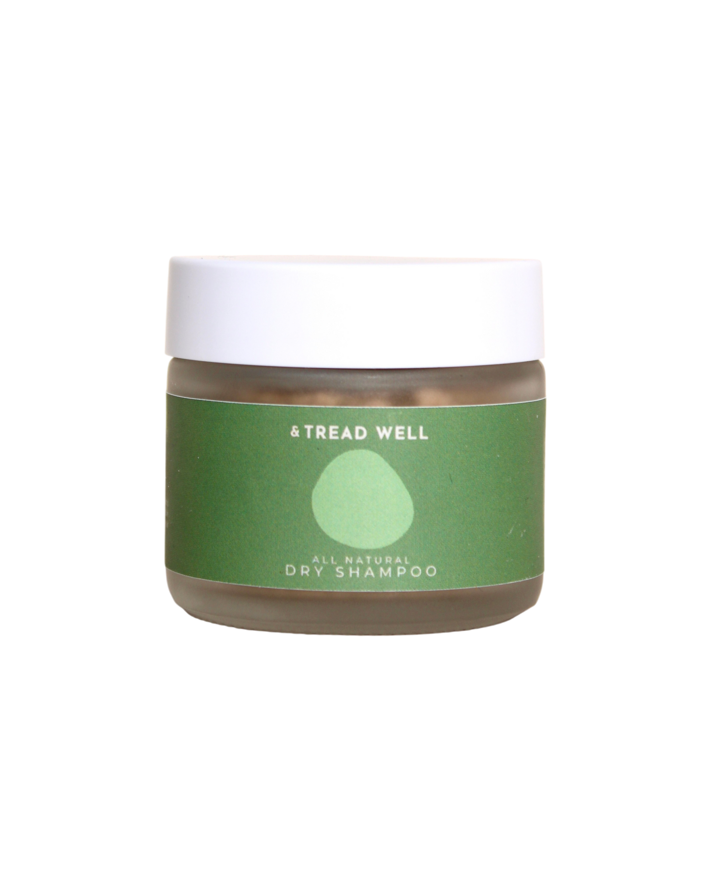A small clear jar with a white lid and a green label reading "& Tread Well Dry Shampoo." This non-aerosol, plant-based hair powder from & Tread Well features a simple leaf or droplet graphic on its packaging.