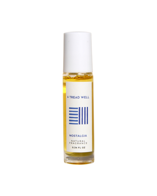 A 0.34 fl oz glass bottle of & Tread Well Natural Fragrance - Nostalgia, with a white cap and minimalist white label featuring blue text and lines.