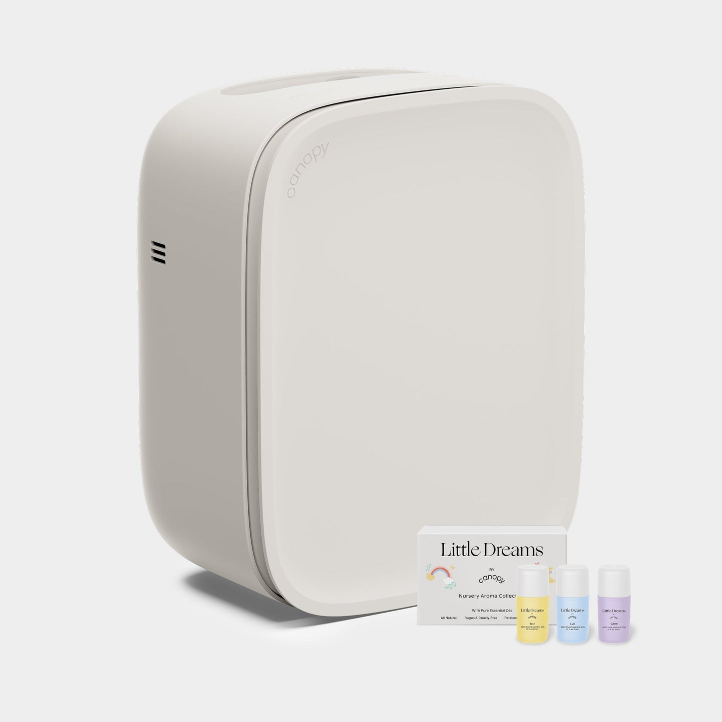 Cream A modern, Canopy Nursery Air Purifier with smooth edges is shown next to three small bottles of aromatherapy oils and a "Little Dreams" card on a plain, light background. Fulfilled by Canopy for your relaxation needs.