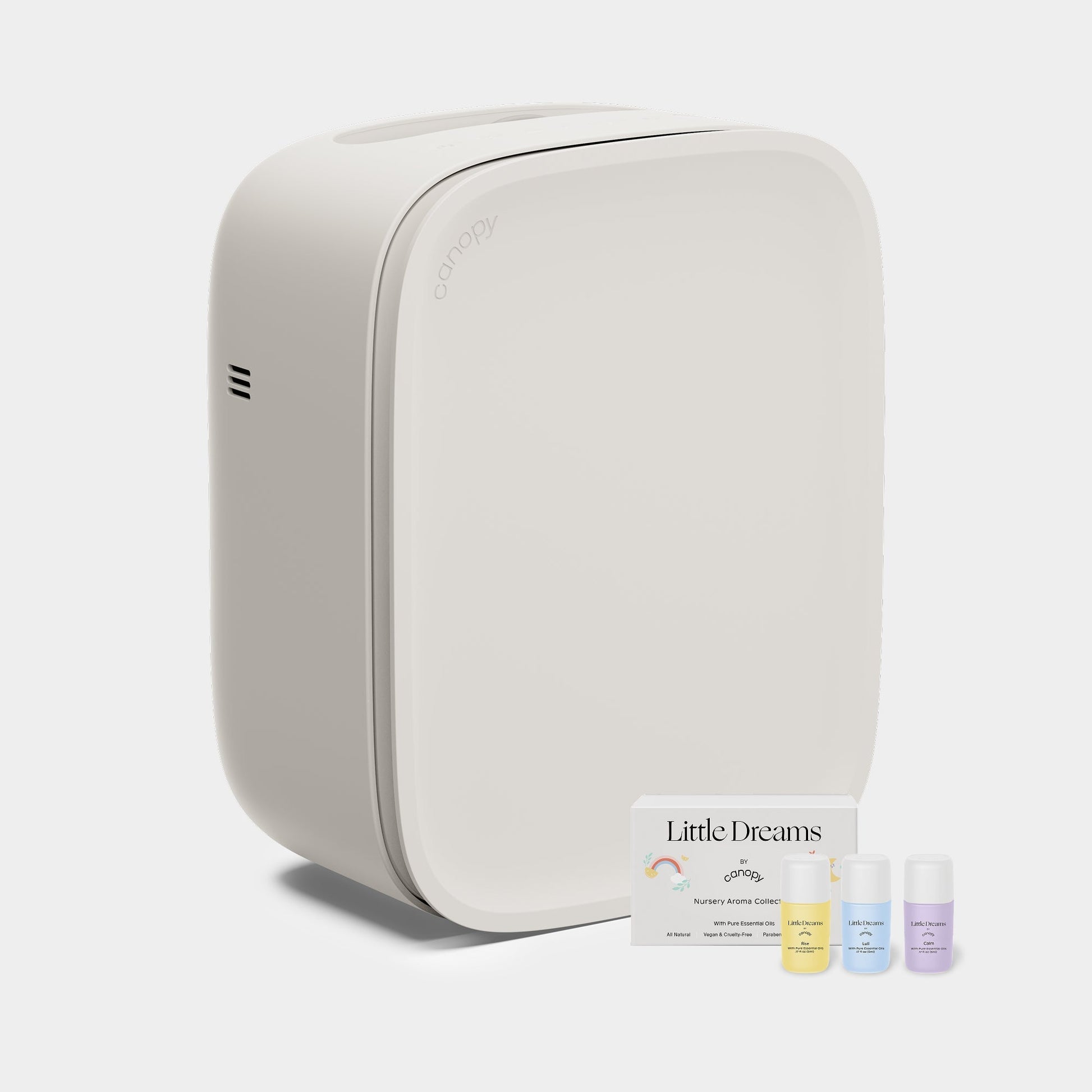 Cream A modern, Canopy Nursery Air Purifier with smooth edges is shown next to three small bottles of aromatherapy oils and a "Little Dreams" card on a plain, light background. Fulfilled by Canopy for your relaxation needs.