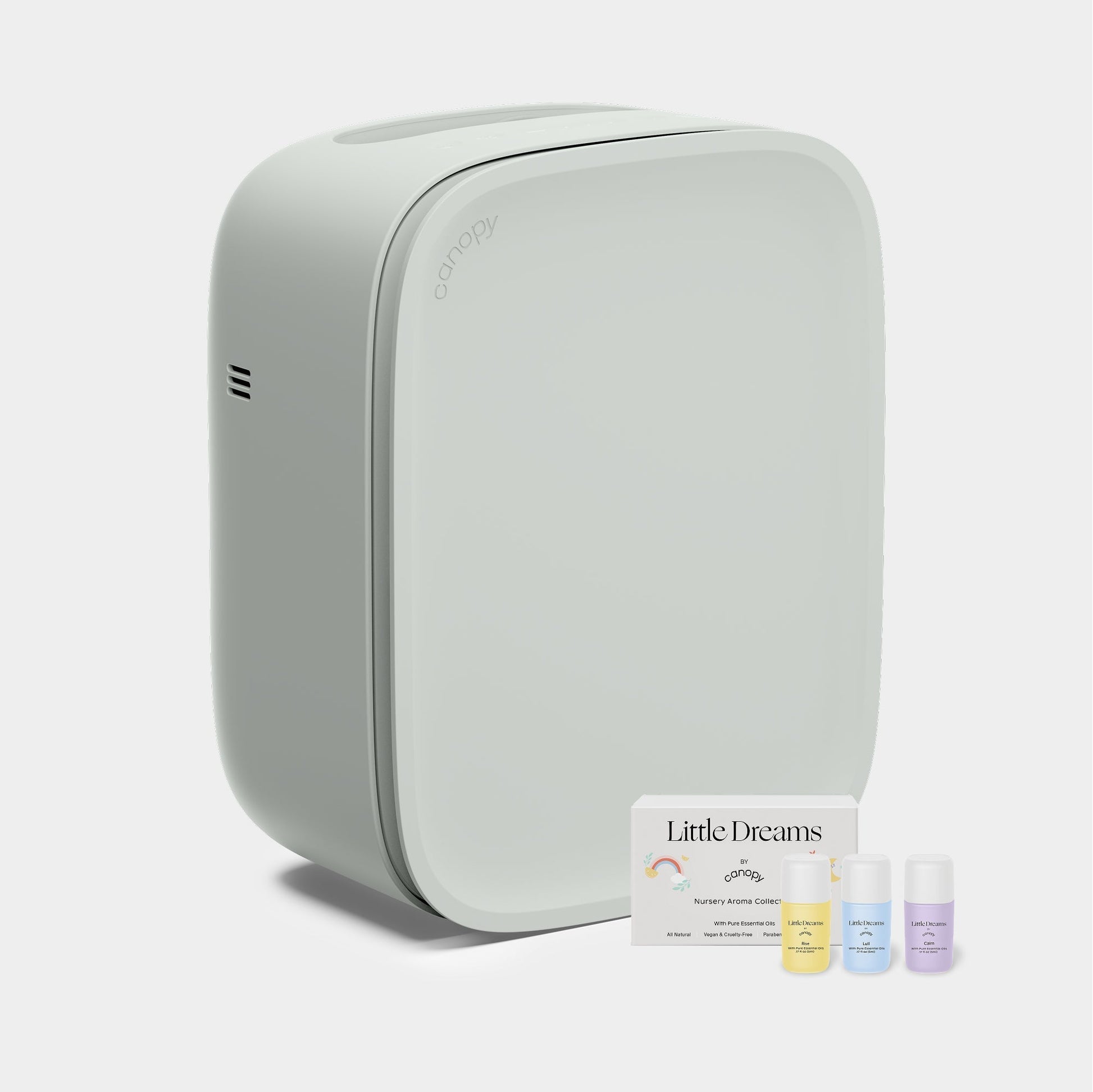 Jade The Canopy Nursery Air Purifier features a sleek, modern design with rounded edges and comes with three essential oil bottles and a "Little Dreams Nursery Aroma Kit" card. Fulfilled by Canopy for peace of mind.