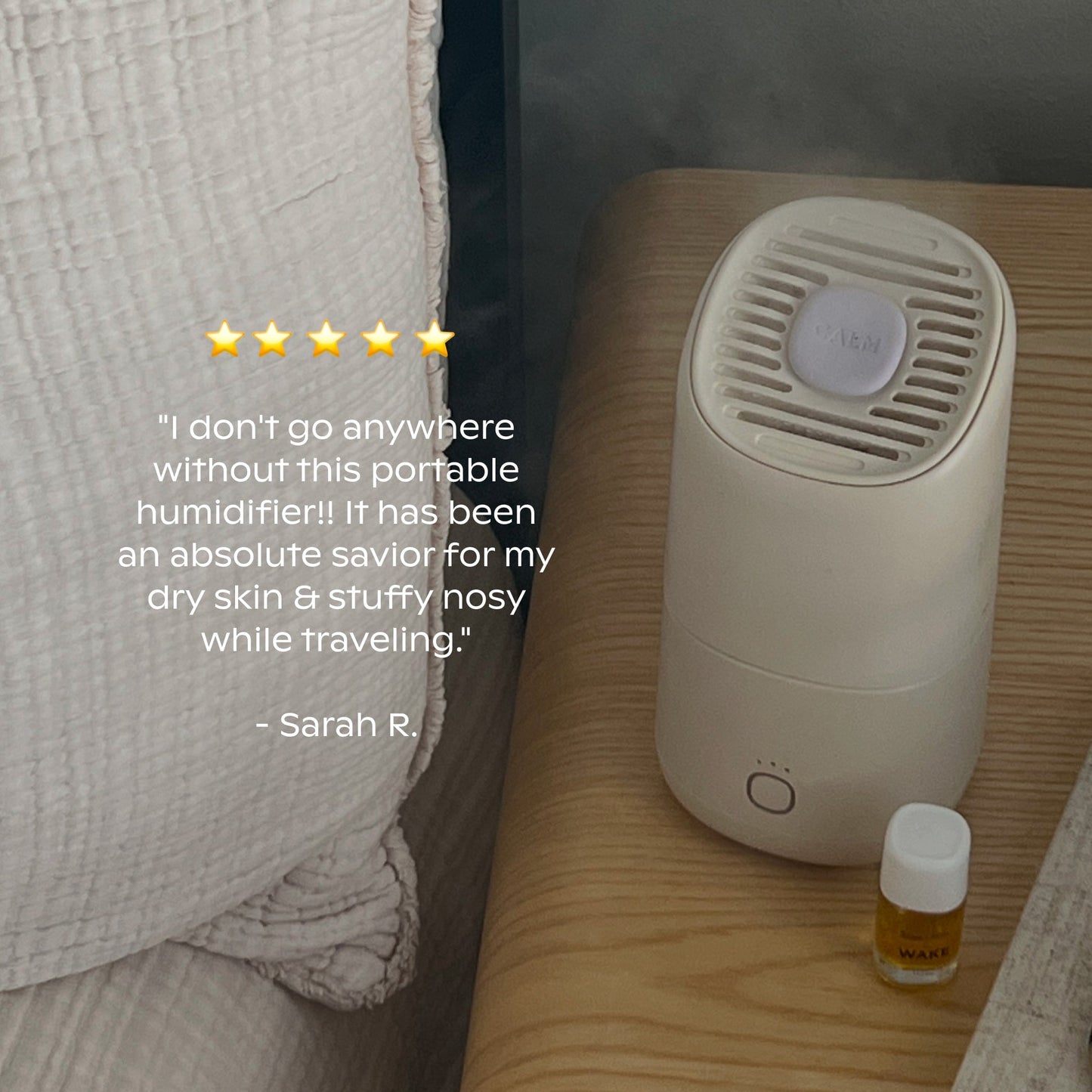 A small, white Canopy Portable Humidifier sits on a bedside table next to a yellow essential oil bottle. A five-star review praises its effectiveness for dry skin and stuffy noses while traveling.