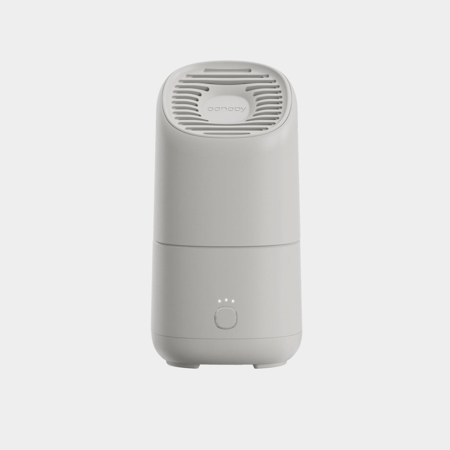 The Canopy Portable Humidifier is a white, modern tabletop device featuring a vented top, circular button, and three front indicator lights, displayed against a plain light background.
