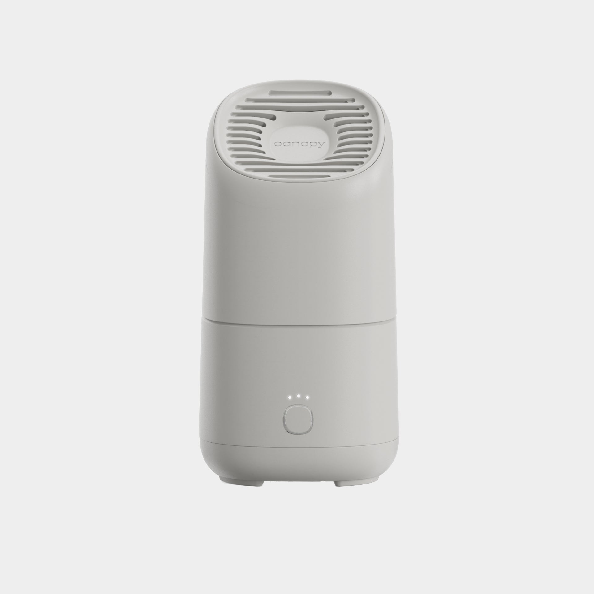 The Canopy Portable Humidifier is a white, modern tabletop device featuring a vented top, circular button, and three front indicator lights, displayed against a plain light background.