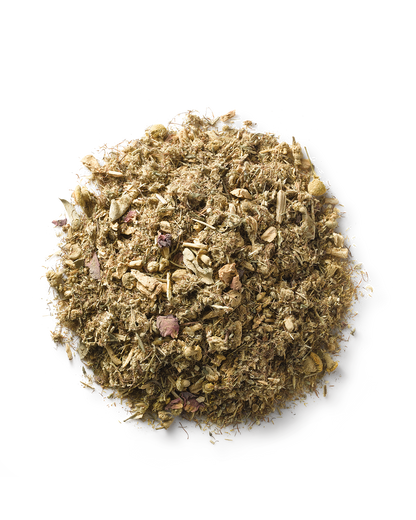 A pile of Ayurvedic herbs on a white background. The finely ground mixture, with small pieces of varied textures and brownish hues, is ideal for enhancing reproductive health through Yoni steam practices using Surya's (y)oni Reset Steam.