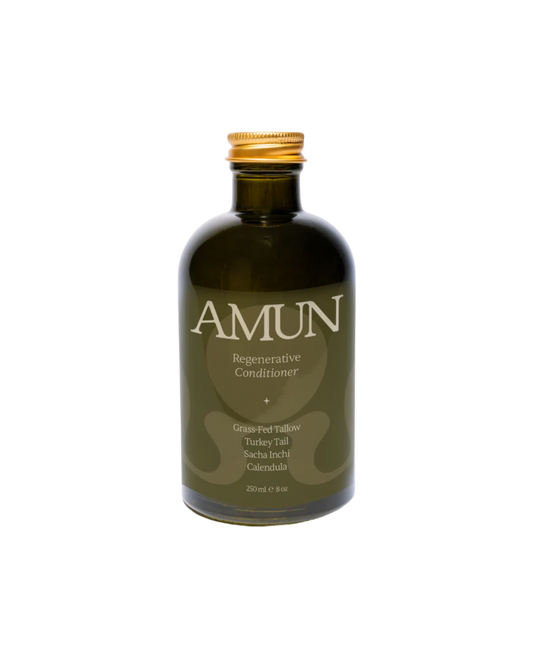 Amun Organics REGENERATIVE CONDITIONER is an organic botanical hair conditioner in a dark green bottle with a gold cap, made with grass-fed tallow, turkey tail, sacha inchi, and calendula; 250 ml.