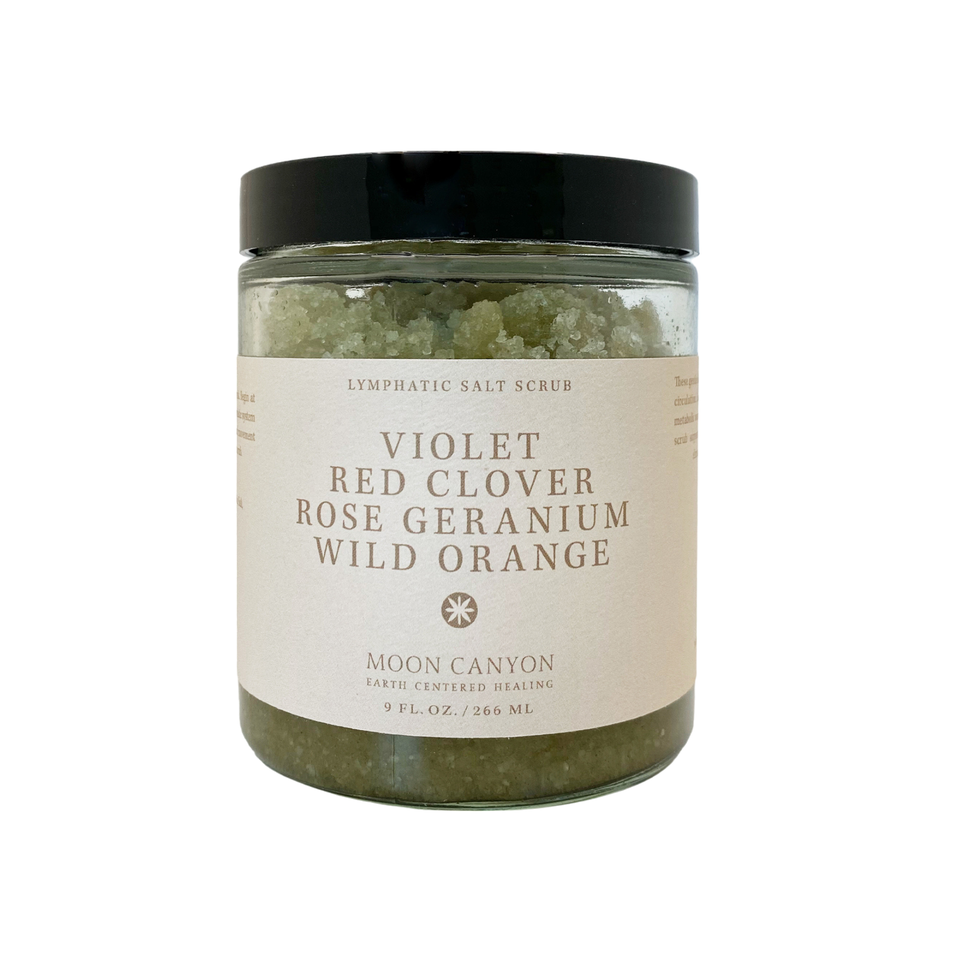 A glass jar with a black lid contains the Violet, Red Clover, Rose Geranium & Wild Orange Lymphatic Salt Scrub designed for skin health. The label reads "Moon Canyon Healing," featuring ingredients such as violet, red clover, rose geranium, and wild orange. It holds 9 fl. oz./266 ml of product, promoting effective detoxification and lymphatic drainage.
