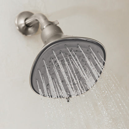 A close-up of the Canopy Filtered Showerhead, finished in modern silver and mounted on a light bathroom wall, spraying multiple streams of water. Fulfilled by Canopy for convenience and peace of mind.