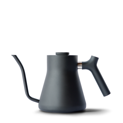 The Stagg Pour-Over Kettle from Fellow Wholesale features a sleek, matte black finish, a precision pour spout, and an ergonomic counterbalanced handle. Its modern, minimalist design ensures perfect control during coffee brewing.