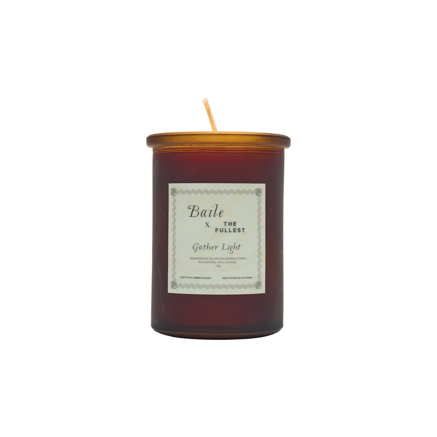 A brown glass jar candle called "Gather Light - Saffron Beeswax Tallow Candle" by Baile features a gold lid and white label. The unlit, centered wick is non-toxic, and the product is shown against a plain white background.